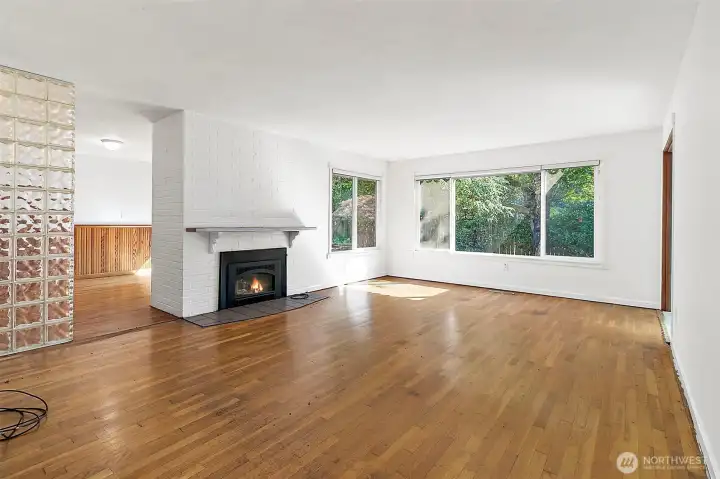 Large windows, door the outside on the left, electric fireplace may have option to convert back to wood