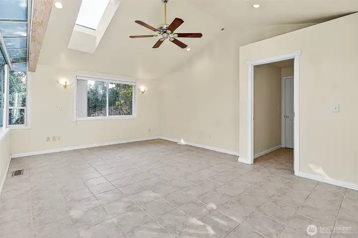 Bedroom 3 is nothing short of gigantic! Easy to convert to 2 bedrooms, for a 4 bedroom home. Ceiling fan, vaulted ceilings and tile flooring
