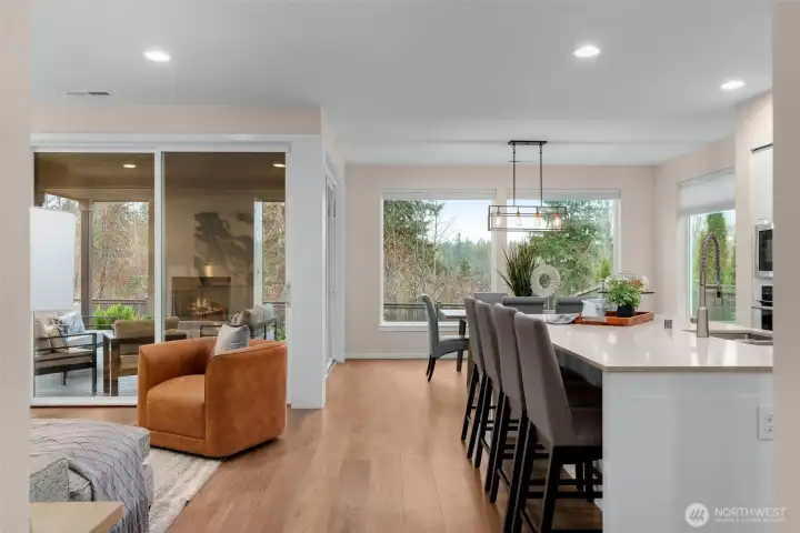 The open concept main level is the hub of the home with access to kitchen, dining, living and outdoor living room.