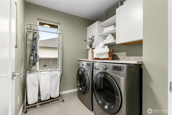 Dedicated laundry space with beautiful front loading washer and dryer.