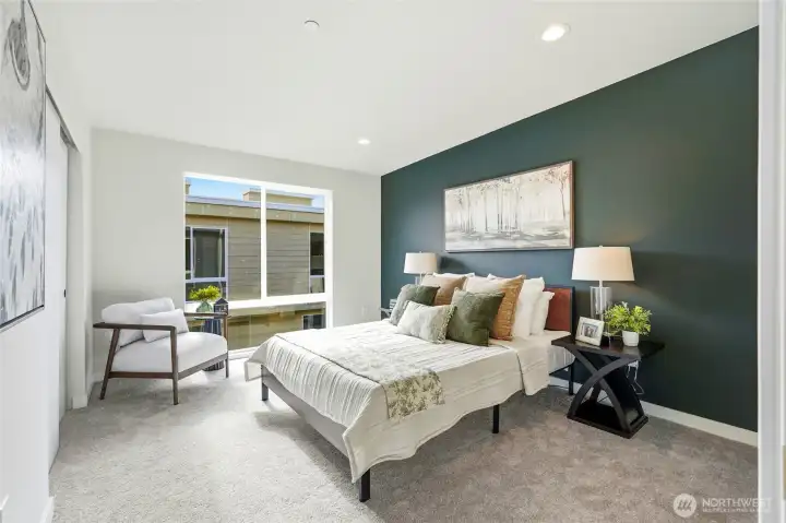 The upper level Primary bedroom has a floor-to-ceiling window that floods the room with light, as well as a walk-in closet and 3/4 bath.