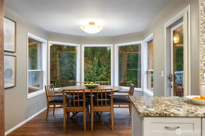 Spacious eat-in kitchen nook leads to upper outdoor deck.