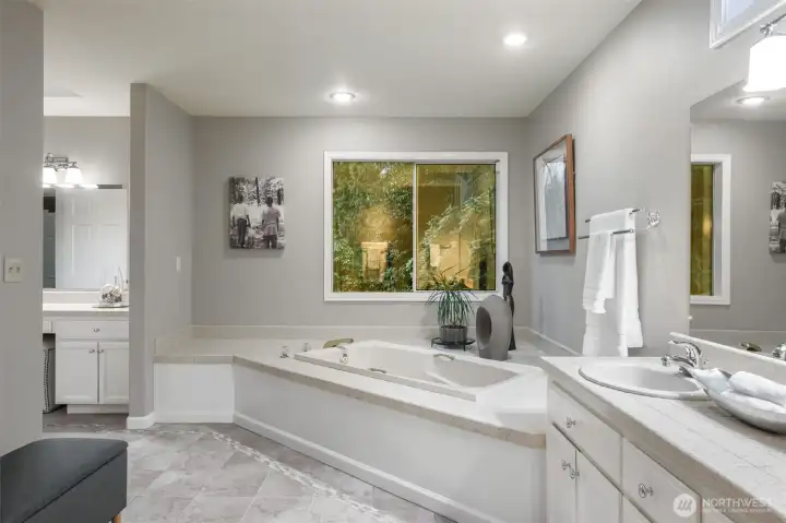 Corner soaking tub with separate tile shower.