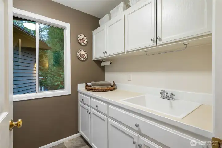 Main floor laundry room with painted cabinets & new sink.
