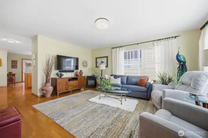 Looking across the spacious living room toward the kitchen and dining area beyond.