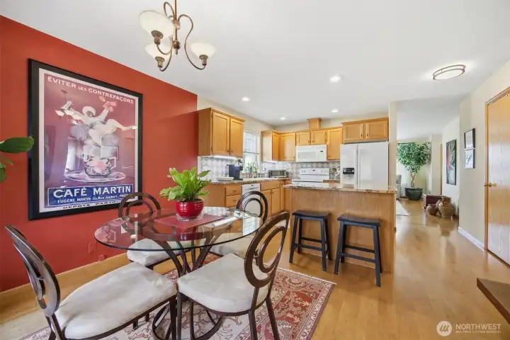 Looking across the dining room and kitchen with the living room beyond.