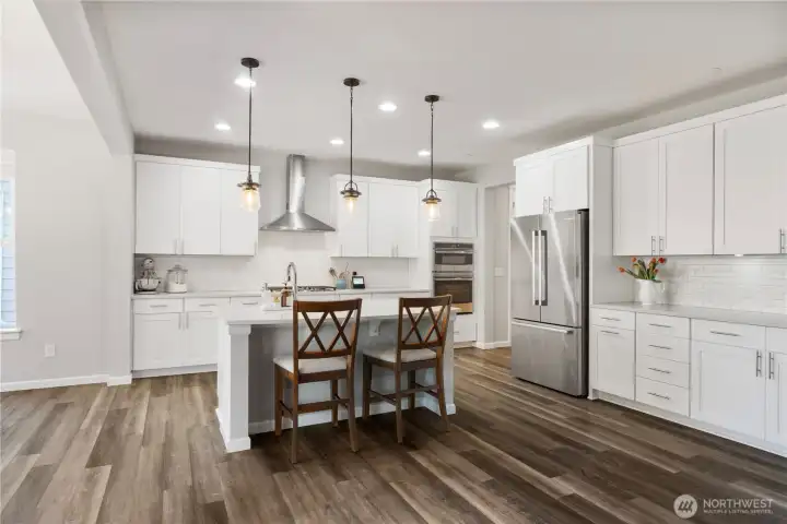 Super spacious kitchen accommodates exceptionally well with TONS of cabinets, yards of counter space and many upgrades to finishes, including cabinet crown molding to "finish out" the top of the cabinets in style.