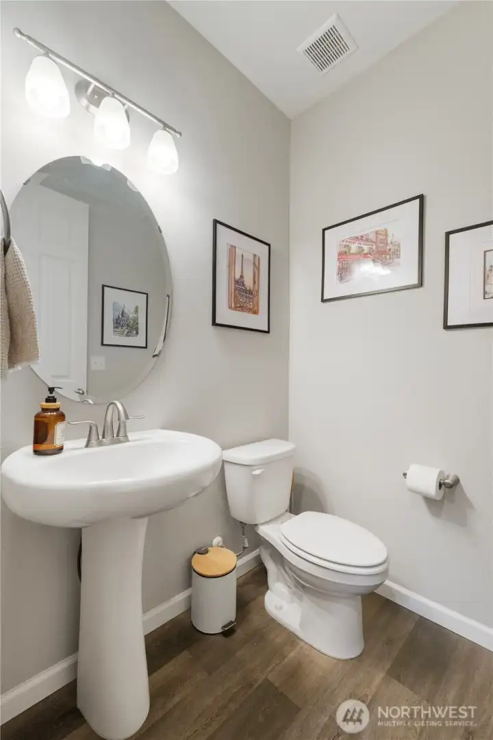 Feng shui-friendly 1/2 bath on the main floor does NOT open to the kitchen or dining. It's tucked away privately, just like it should be.