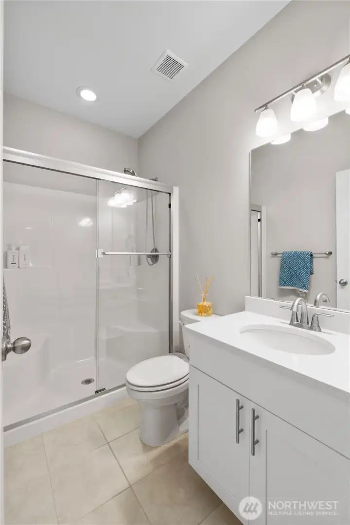 Downstairs has ALL the flex / generation space you'll need, including this FULL bath. Very convenient to generational living.
