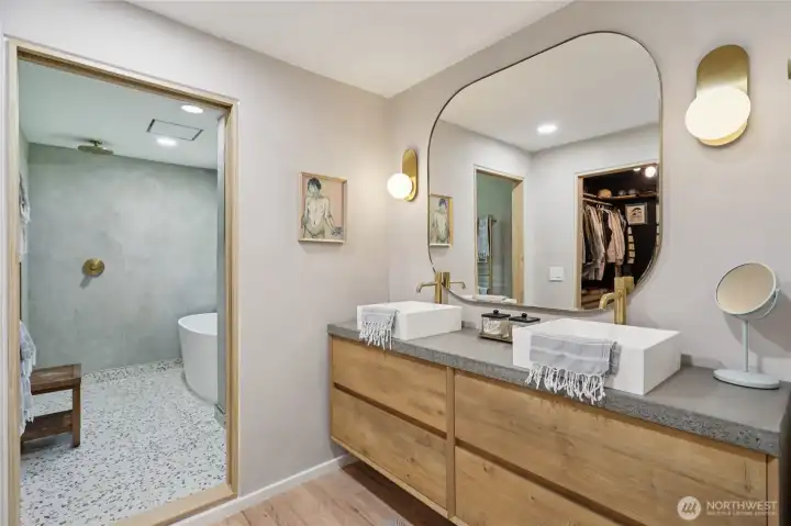 Euro style wet-bath includes custom vanity, Tadelakt plaster, volcanic limestone soaking tub & solid brass fixtures