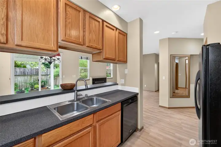 Kitchen with breakfast bar keeps you connected, ideal for casual meals or entertaining.