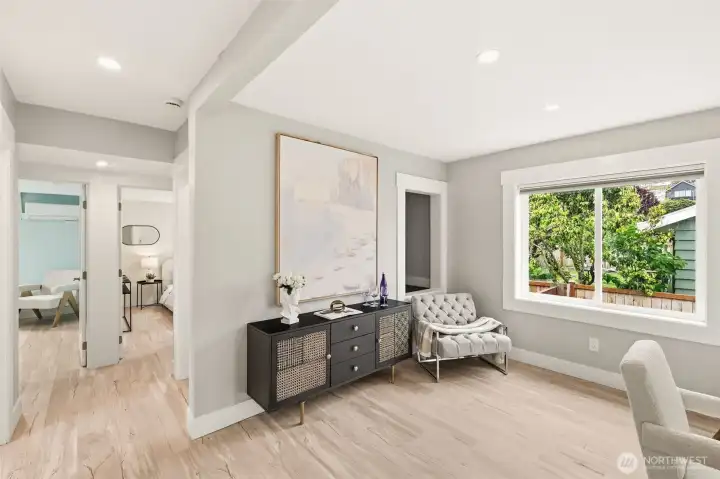 Engineered hardwood floors and oversized windows create a light and bright home