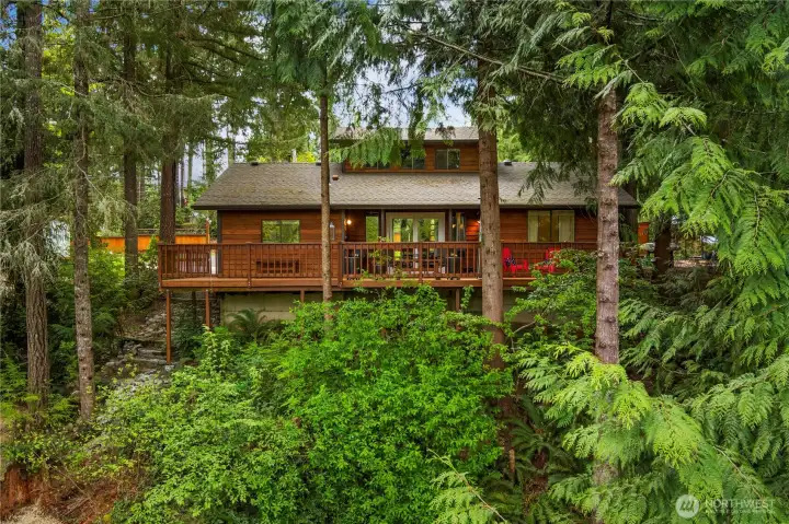 Lovely lake view home surrounded by trees and access to the private members only beach