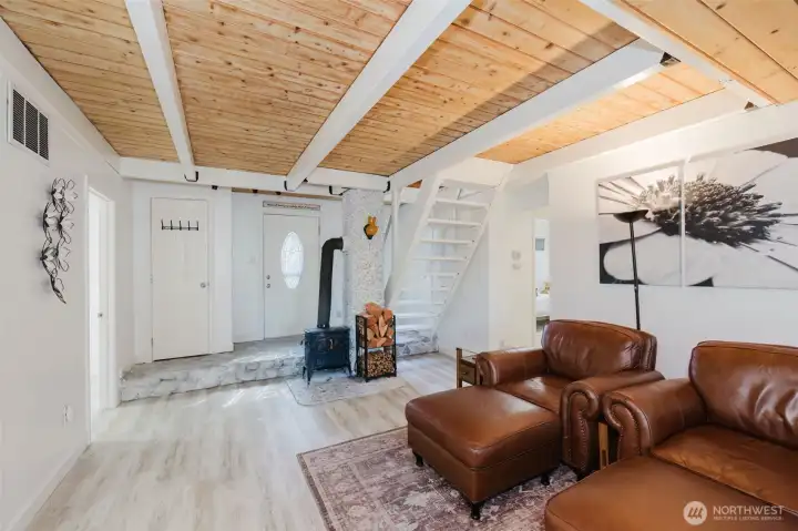 Entry way is river rock.  Wonderfully cozy freestanding wood stove in central location.  Even heats the loft if you need.