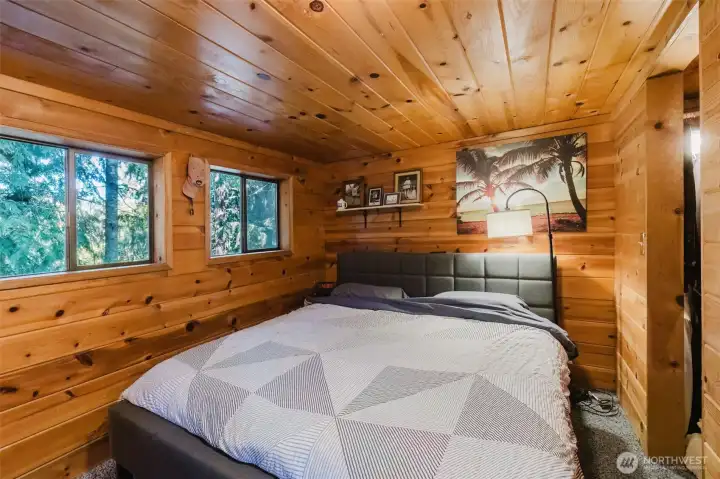 Loft area wrapped in natural wood.  Windows have beautiful view of the lake beneath the private solitude of the trees.  Seller currenly using this as the primary bedroom