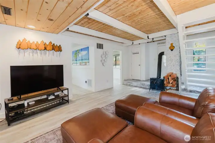 living room showing kitchen door and laundry room door as well as the entry