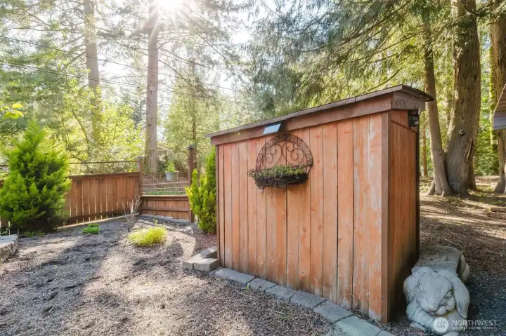 woodshed, partially fenced front yard