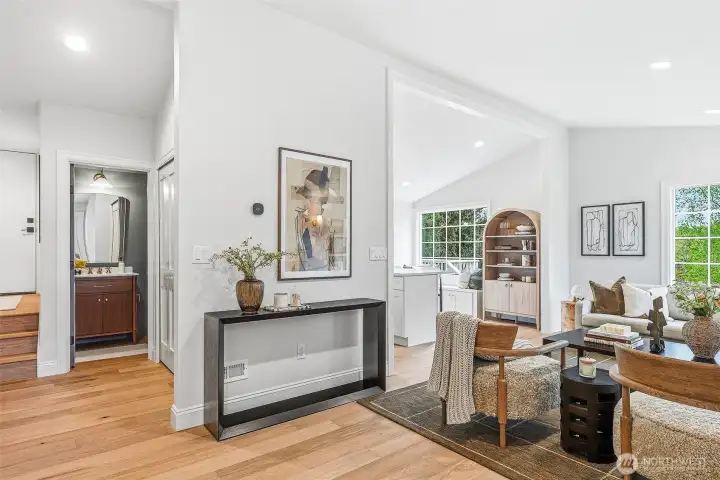 Living areas and the two bedrooms on the main level are nicely separated for peace, quiet and privacy. Half bath is tucked into the mudroom area with great storage, shoe bench, and garage access through the door at the top left of the photo.