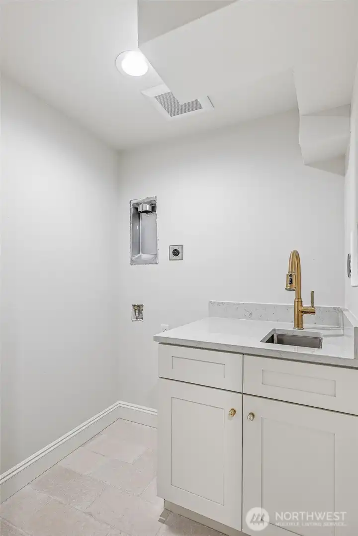 Utility room on the lower level with washer/dryer hookups and a handy utility sink.