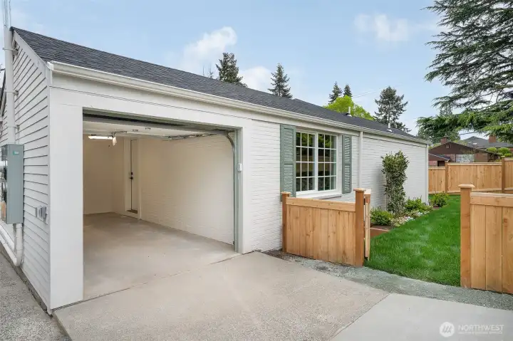 The EV-ready garage and extra driveway space make it easy to leave the car at home and explore this fantastic, beloved neighborhood. Through the mandoor inside the garage you enter the house via a mudroom with lots of closet space and a bench.