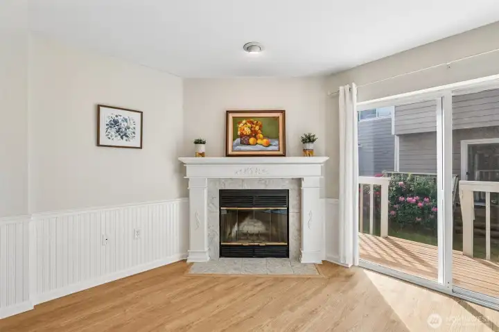 Cozy up beside the wood-burning fireplace or step outside through the sliding door to the private deck. Cozy up beside the wood-burning fireplace or step outside through the sliding door to the private deck.