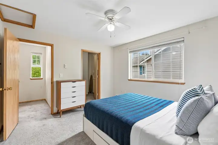 Another view of the primary bedroom highlights its generous proportions and adjoining walk-in closet. Another view of the primary bedroom highlights its generous proportions and adjoining walk-in closet.