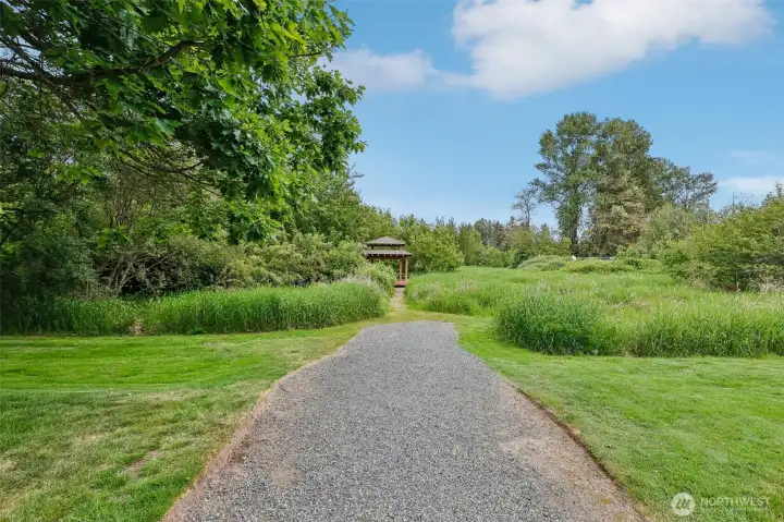 Private community trails wind through the greenbelt and lead toward the covered picnic area. Private community trails wind through the greenbelt and lead toward the covered picnic area.