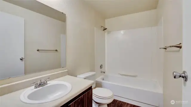 Centrally located full bath between the main living space, bedrooms & entry.