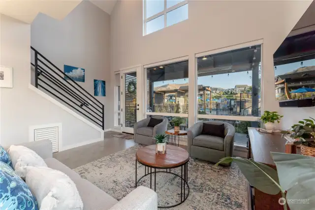 View 4 of the Great Room/Living Room w/ vaulted ceilings, oversized windows and doors leading to the outdoor living area.