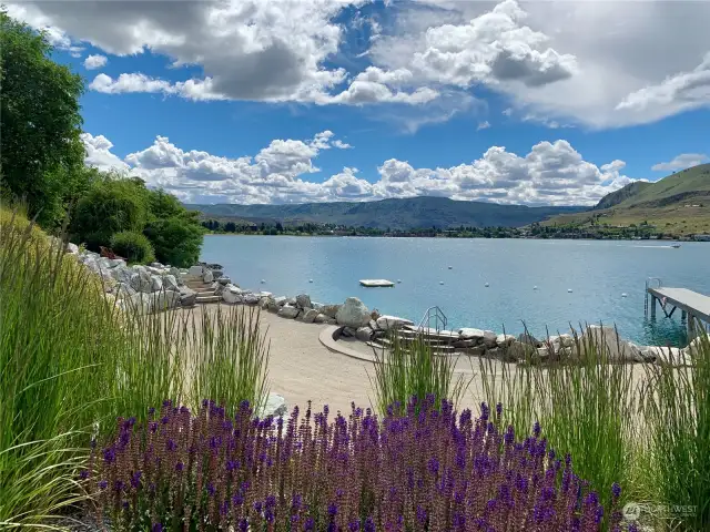 View of The Lookout's private waterfront with sandy beach cove and swimming area.