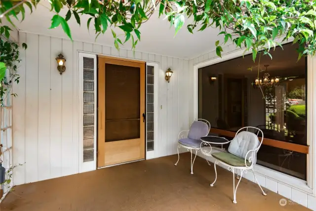 Covered entry porch to enjoy the view of the landscaped yard.