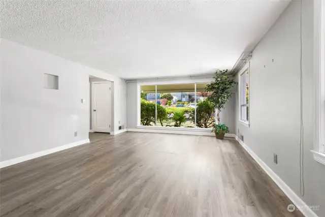 Living room with floor to ceiling windows.