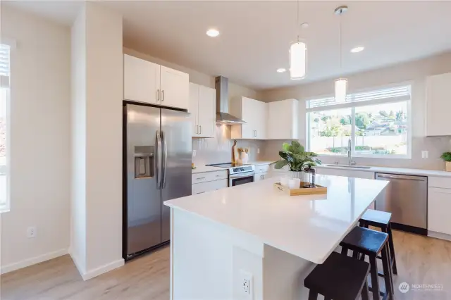 Image of Homesite #1 kitchen offering white cabinets & white quartz.