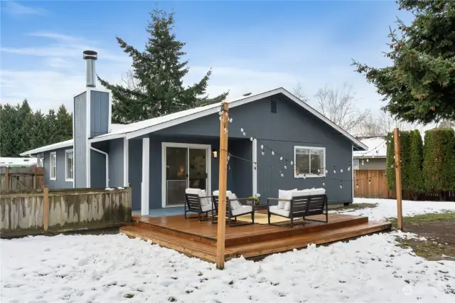 Partial view of dog run beyond short fence.  Back & side yards in view.