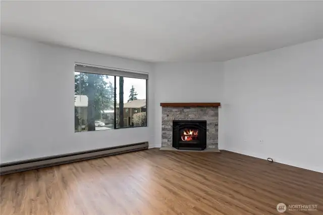 Beautiful wood fireplace with updated surround and mantle.