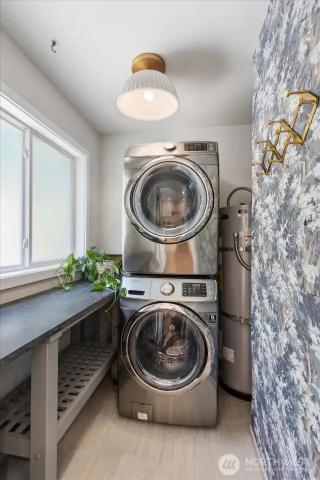 Laundry room with tile floor, wallpaper and custom granite countertop