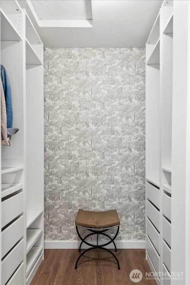 Walk in closet with built in hanging and drawers