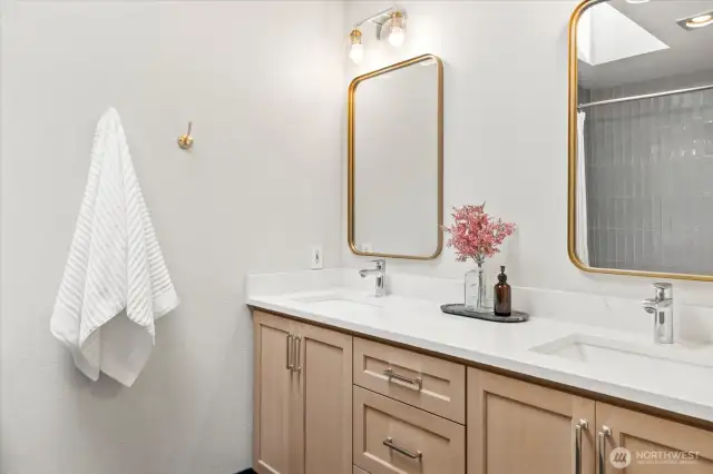 Primary bathroom double vanity with quartz countertops