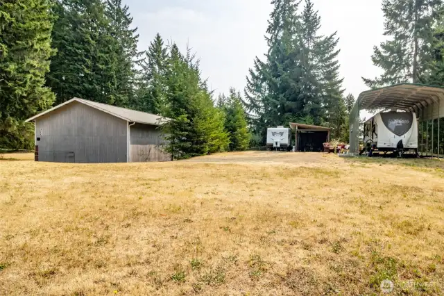 Covered RV parking and large yard area