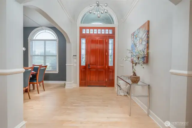 Elegant entry welcomes you with soaring ceilings, arched transom window, expansive custom trim.