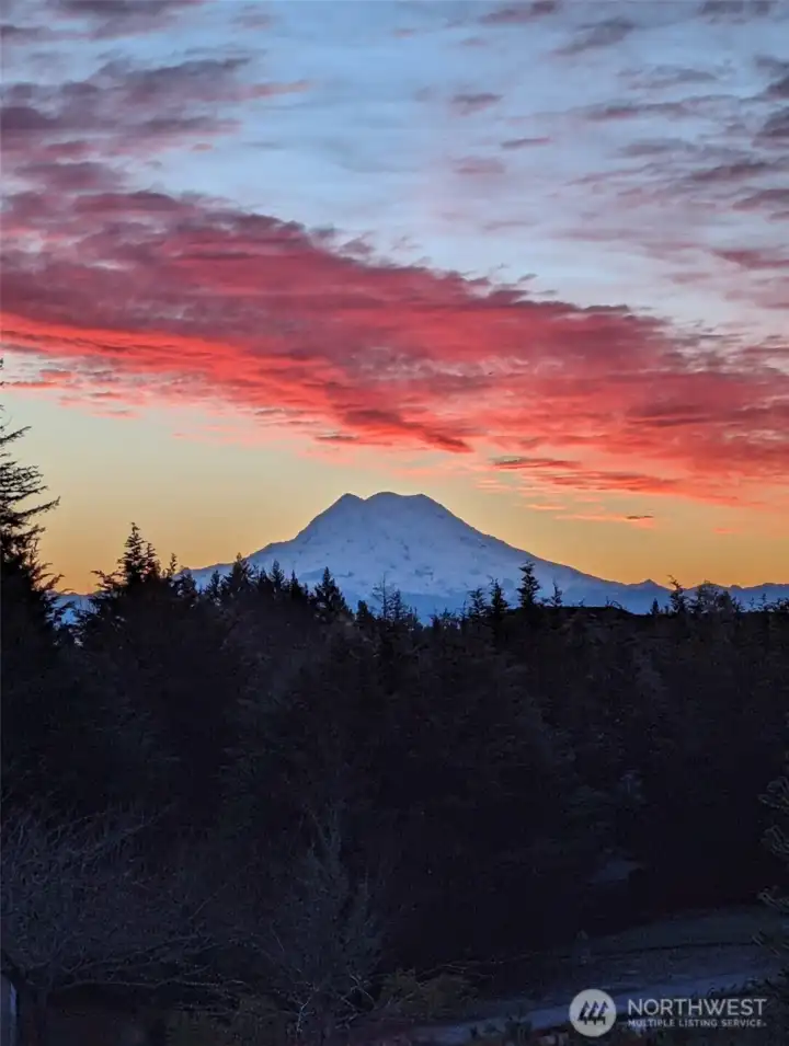 Breathtaking sunset view of the ever-majestic Mt. Rainier framed by vibrant skies.