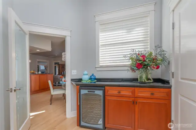 Butler’s pantry just off the kitchen, featuring granite counters, cherry cabinetry, and a built-in wine refrigerator—perfect for entertaining and extra storage.