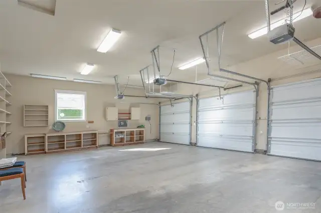 Huge 3 car garage, with work benches, all doors with openers, fully finished including trim to match the homes interior.