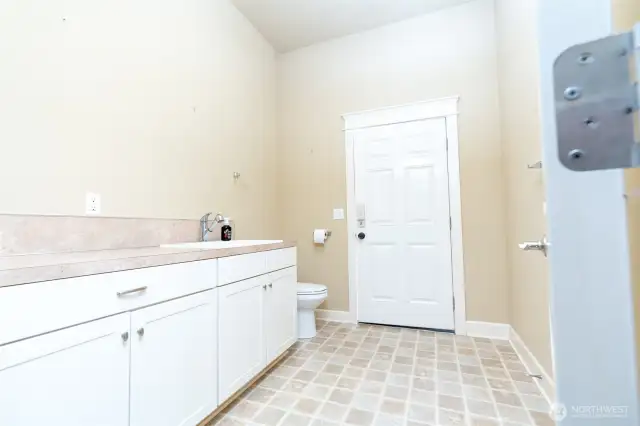 1/4 bath off garage, back door leads to back yard.