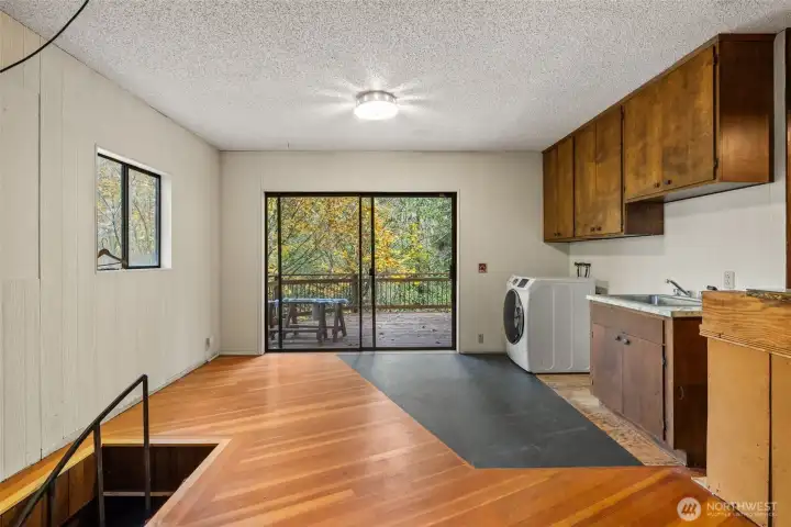 Laundry area w/spiral staircase keading to basement