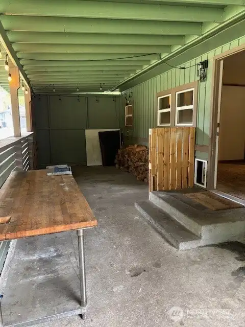 Outside back porch entry into the house next to the carport