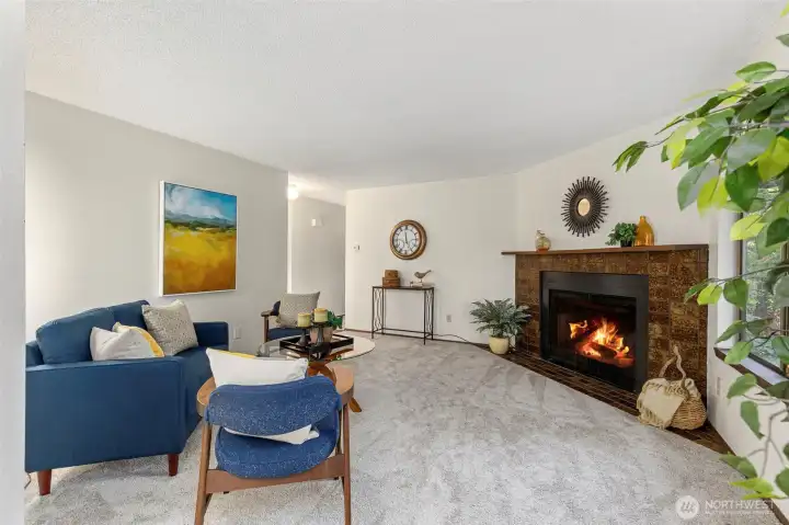 Cozy wood burning corner set fireplace in living room on the main floor