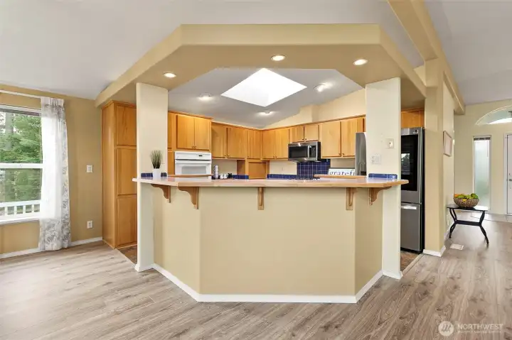 Open, easy living kitchen with a breakfast bar and ample storage