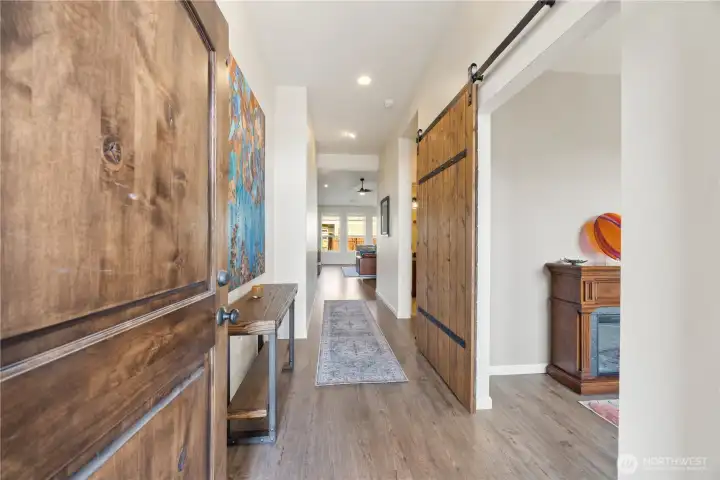 Light bright entry hallway 9' ceilings leads into the vaulted open great room with wood burning fireplace.
