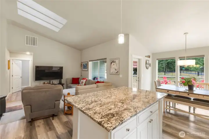 Kitchen island with eating space and additional cabinet storage.
